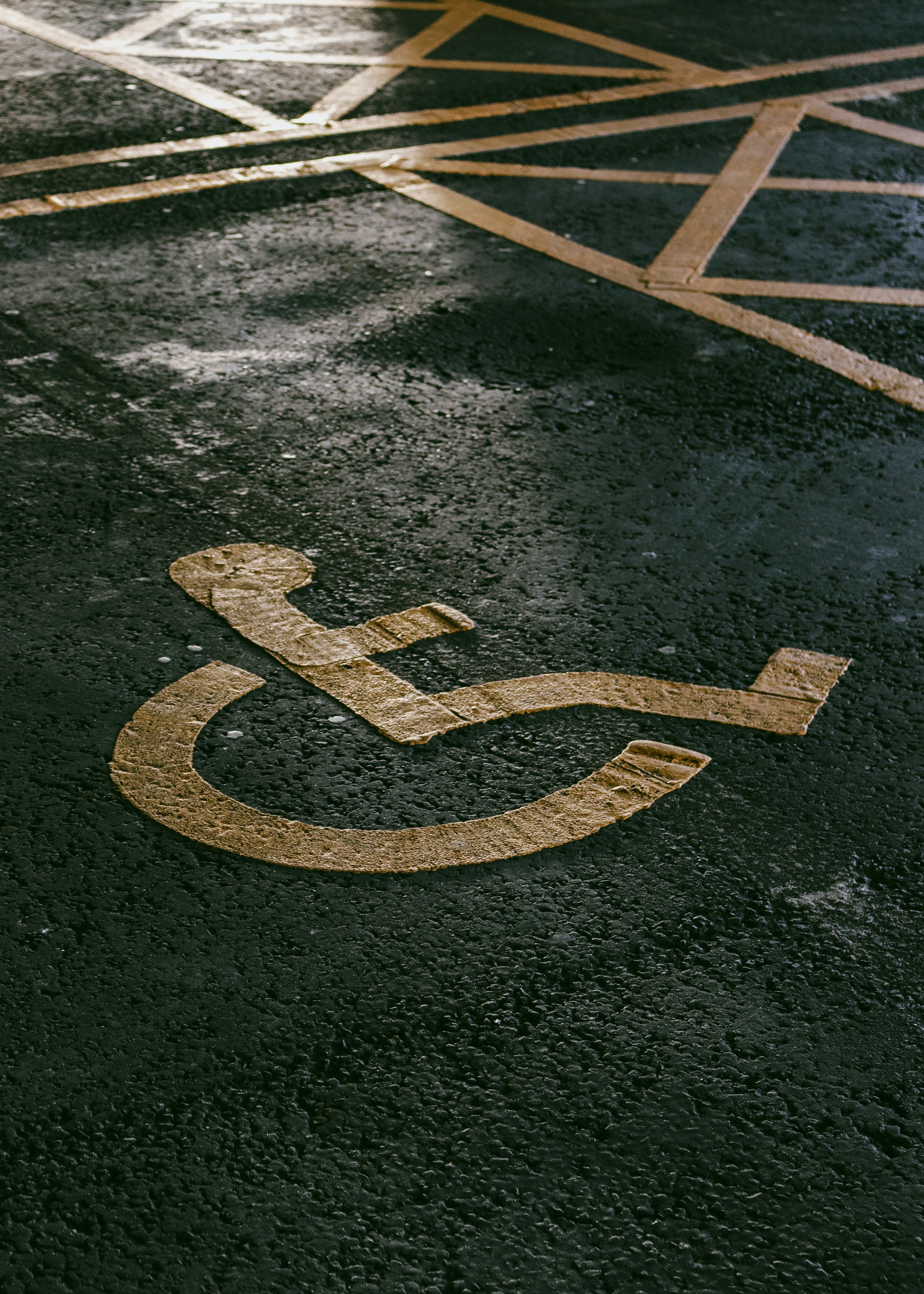 Disabled parking. Accessible parking spot. Blue badge. Yellow wheelchair sign on the ground
